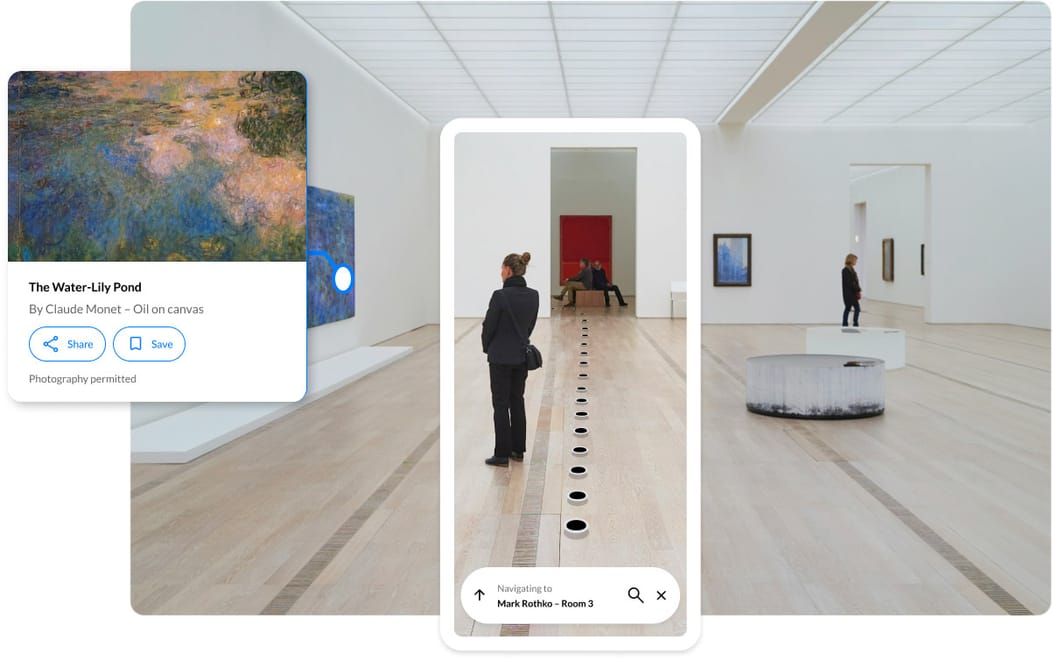 Visitor standing in a museum gallery using a smartphone with the Spaces indoor navigation
